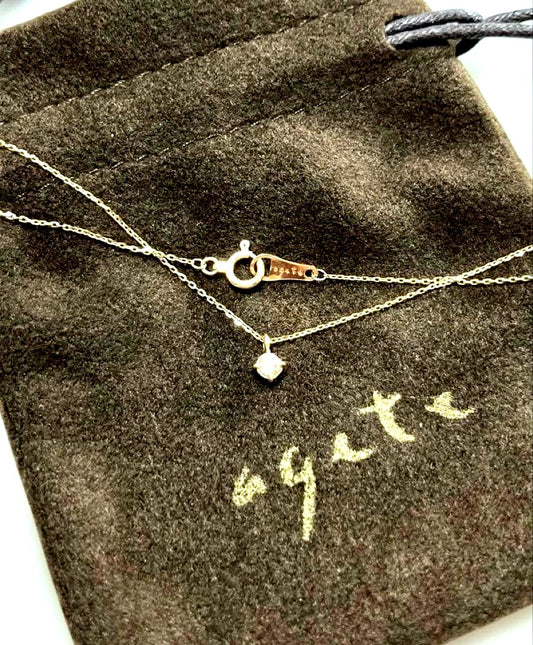 K10 gold diamond necklace by agete with 0.07 carat diamonds displayed on white background