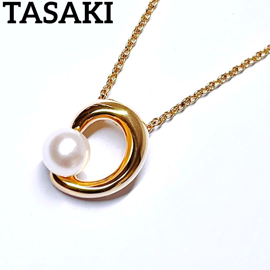 Tasaki pearl necklace pendant with 6.4 mm silver pearl and 45 cm gold chain on white background