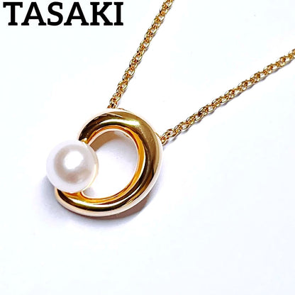 Tasaki pearl necklace pendant with 6.4 mm silver pearl and 45 cm gold chain on white background