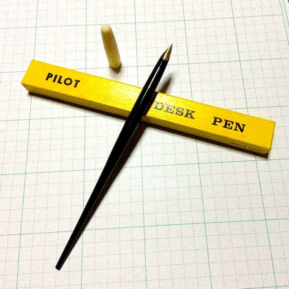 Black Pilot Desk Pen with 14K gold nib showing scratches and discoloration, accompanied by damaged storage box