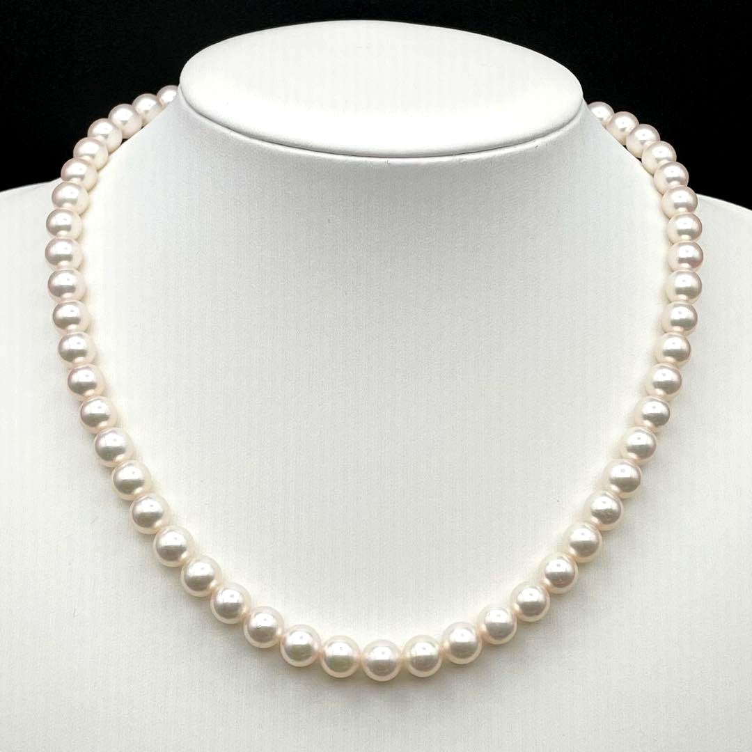 Tasaki Akoya pearl necklace with 7.0-7.5mm pearls and silver clasp on a white background