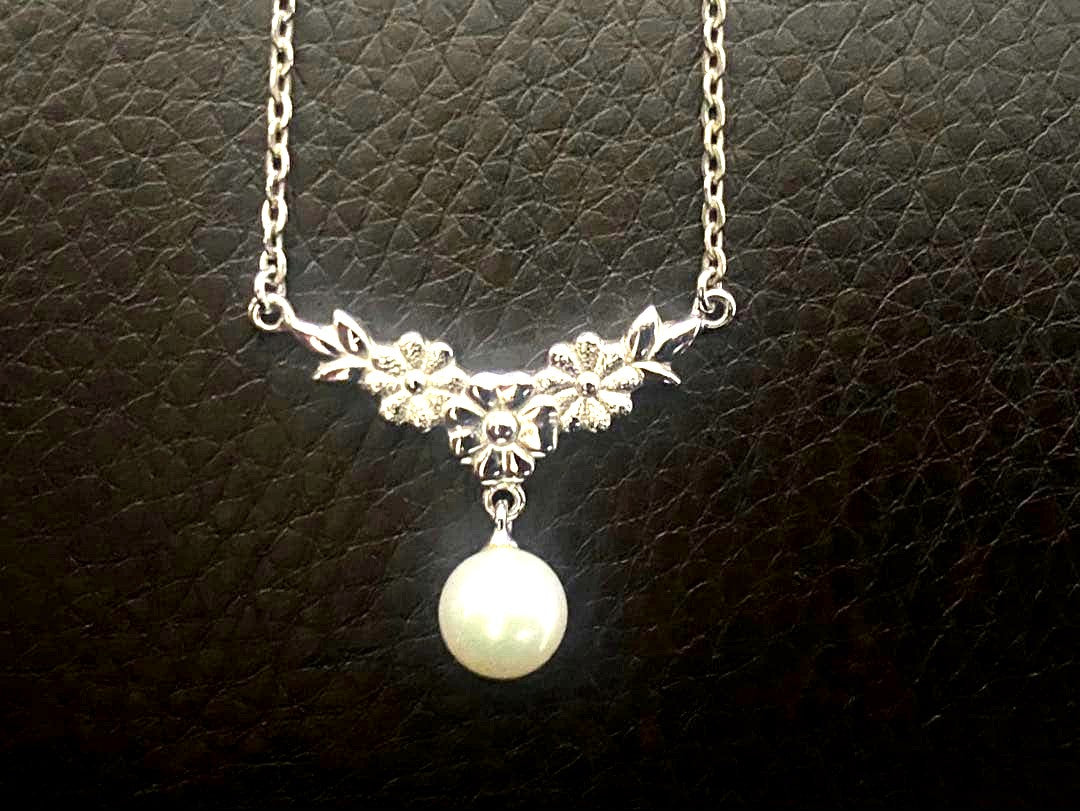 Mikimoto genuine pearl necklace with 40cm sterling silver chain on white background