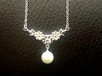 Mikimoto genuine pearl necklace with 40cm sterling silver chain on white background