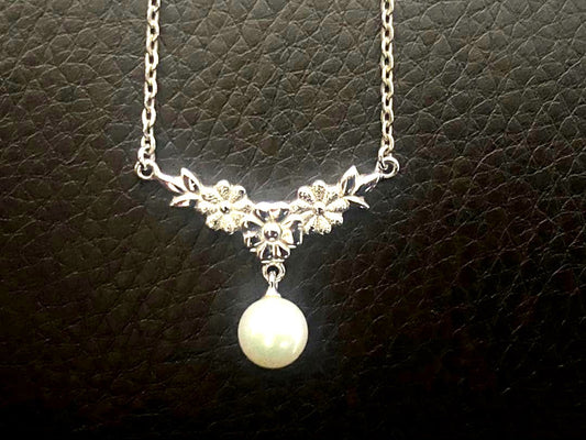 Mikimoto genuine pearl necklace with 40cm sterling silver chain on white background
