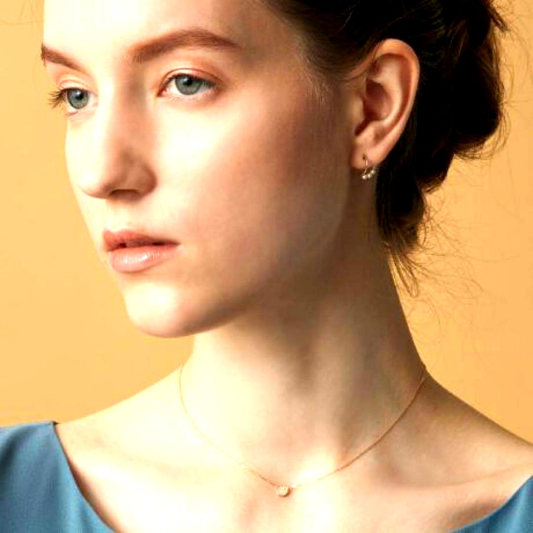 Kuro Diamond Necklace made of 18K gold featuring multiple small micro-set diamonds on a delicate chain
