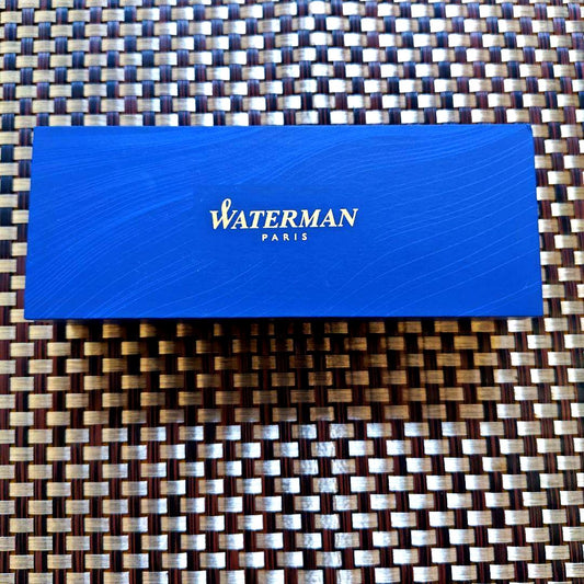 Waterman black fountain pen with blue ink cartridge and dedicated black case on white background