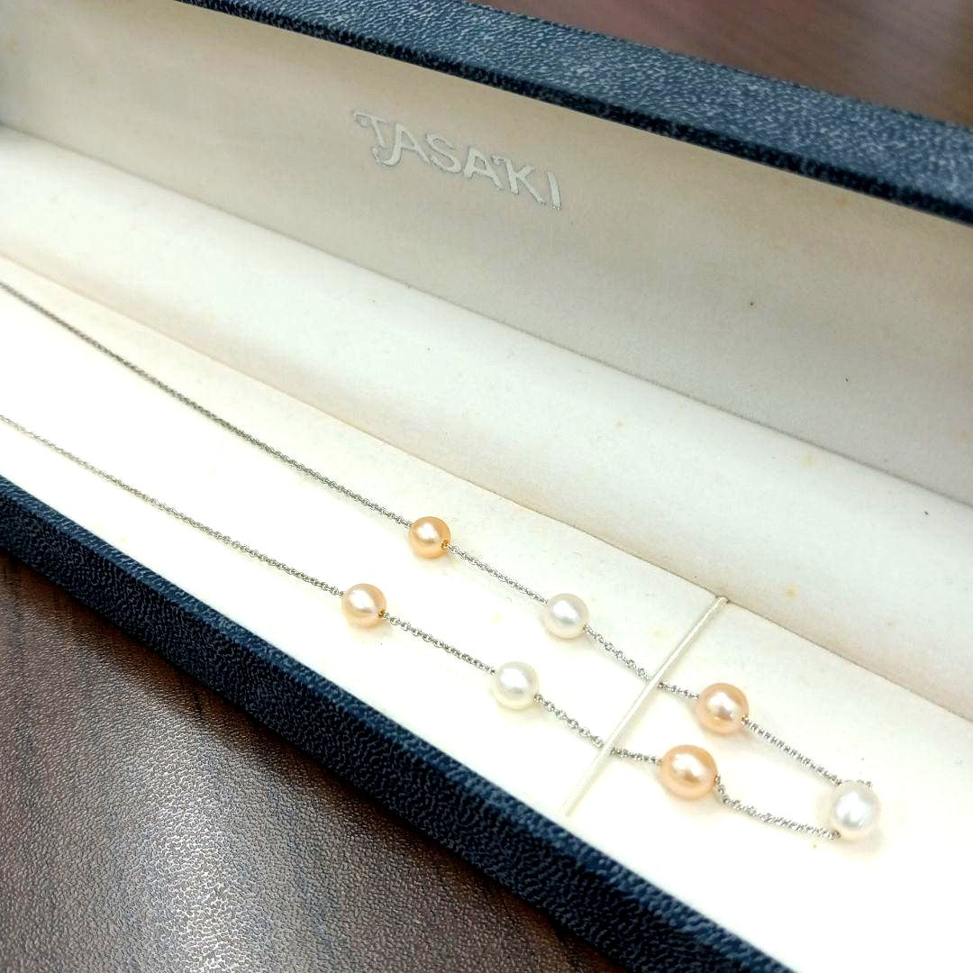 Tasaki pearl necklace made of silver with 40 cm total length displayed on a white background