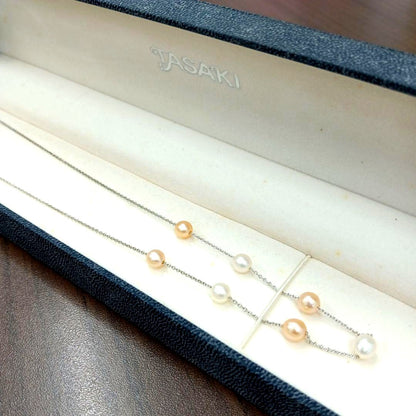 Tasaki pearl necklace made of silver with 40 cm total length displayed on a white background