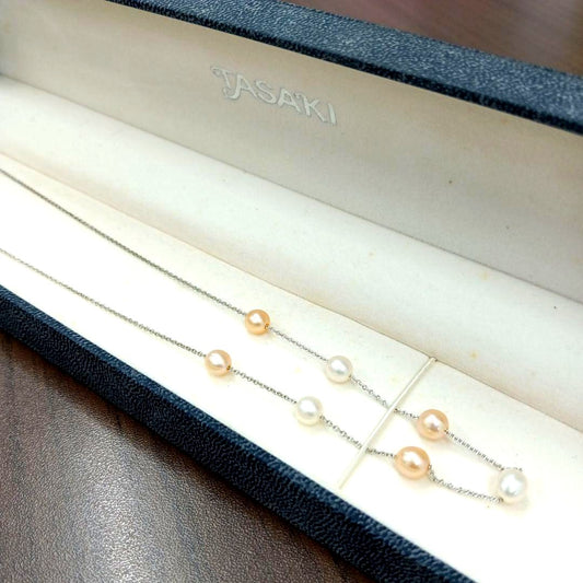 Tasaki pearl necklace made of silver with 40 cm total length displayed on a white background