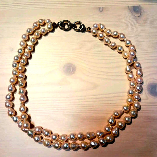 Two-row Akoya pearl necklace about 40cm long with clasp on white background