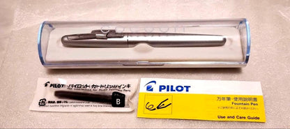 Pilot Kakuna Silver fountain pen with medium nib shown unused with packaging and black ink cartridge