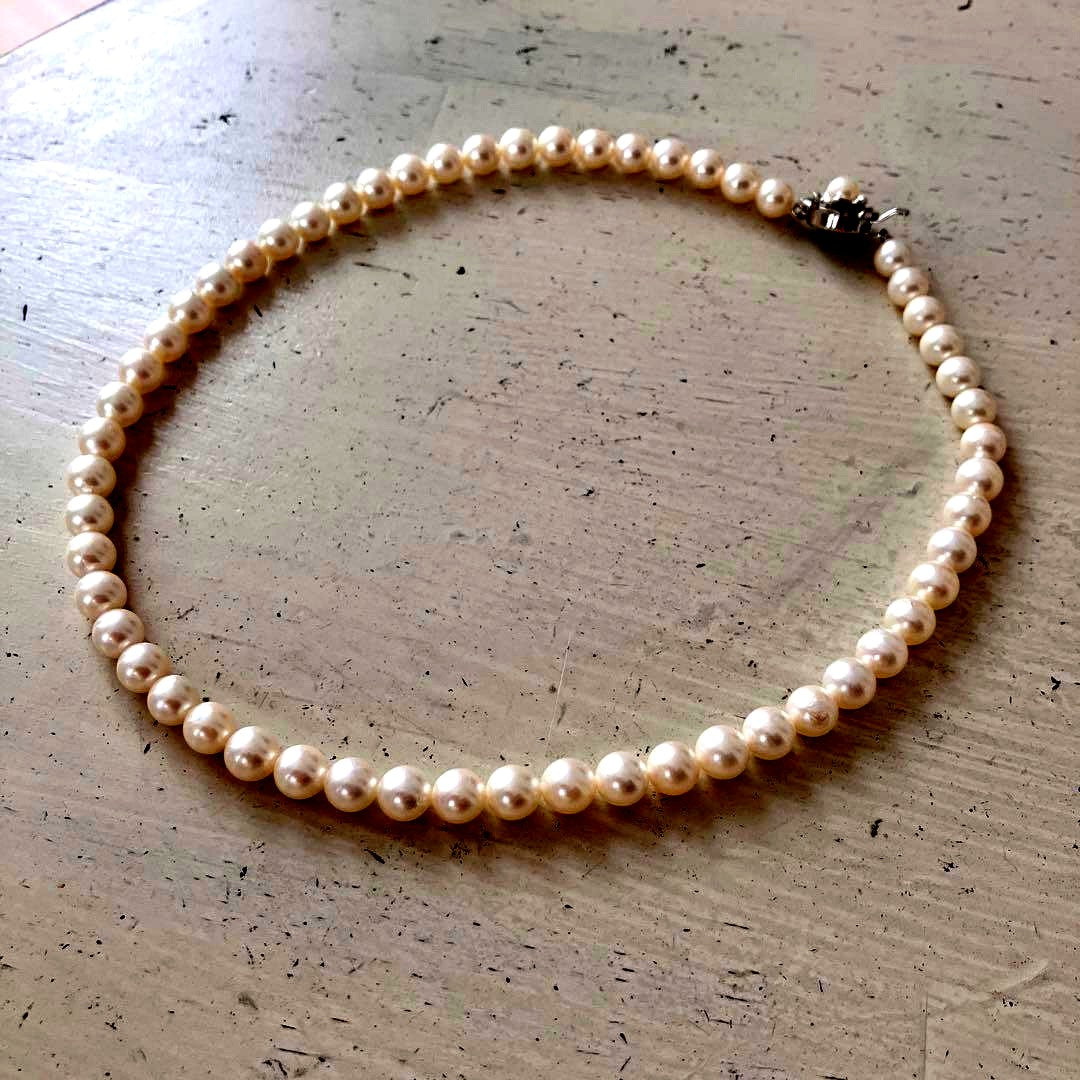 Akoya pearl necklace in silver with 6mm pearls and 44cm length displayed on white background