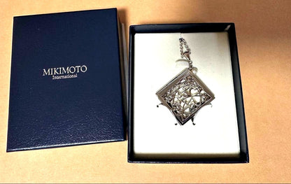 Mikimoto Loupe Pearl Chain Necklace with round pearls and fine chain alongside a small loupe accessory