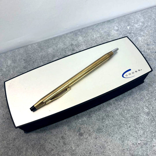 Cross ballpoint pen with gold color finish and dedicated black case displayed on white background