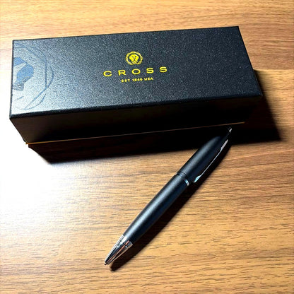 CROSS ballpoint pen in matte black finish with its dedicated protective case opened beside it