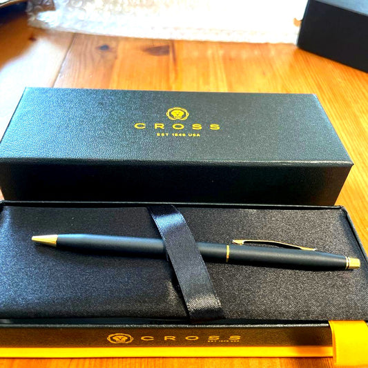 CROSS ballpoint pen with matte black body, gold clip, and matching protective case