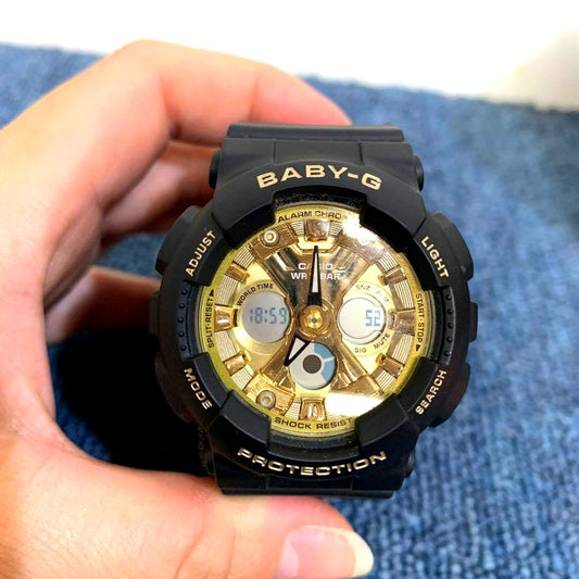 Used Casio Baby-G Black and Gold wristwatch Model 5607 with minor scratches and worn belt in original box