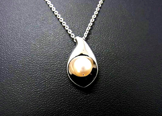 Tasaki pearl necklace with 6mm pearls and 16-inch length displayed on a white background