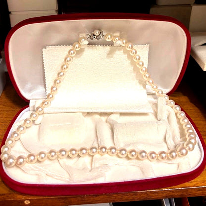 Tasaki Akoya pearl necklace with 8mm pearls and silver fittings laid out flat