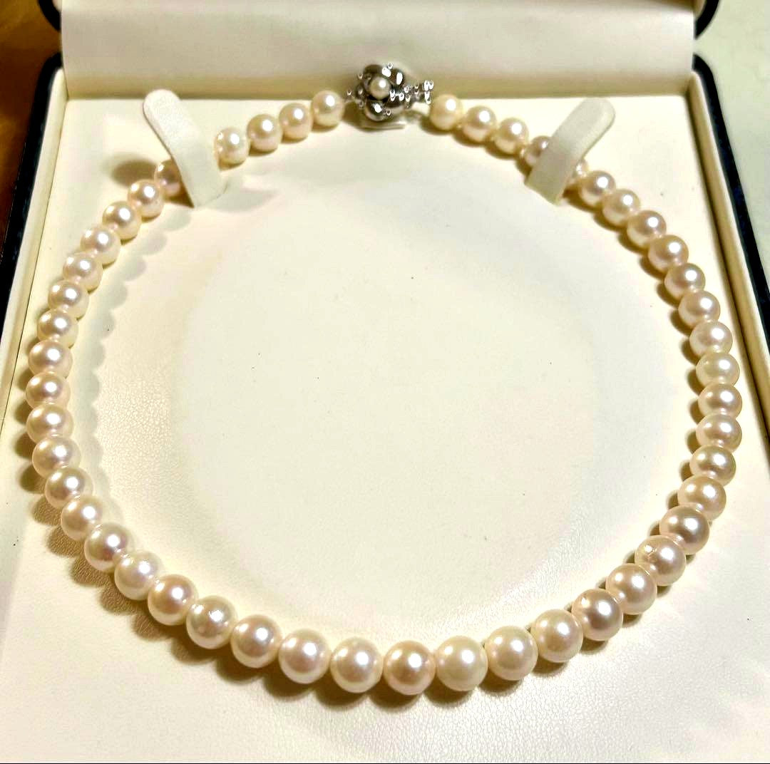 Close-up of Akoya pearl necklace with 8.4mm pearls measuring 42cm in length on a white background