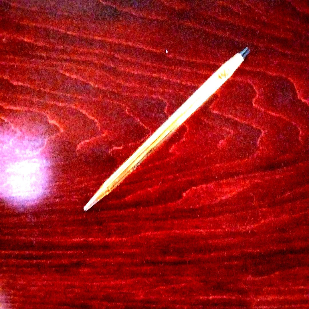 Cross brand gold plastic ballpoint pen with metal clip and twist mechanism, black ink, slightly slim and unused but aged