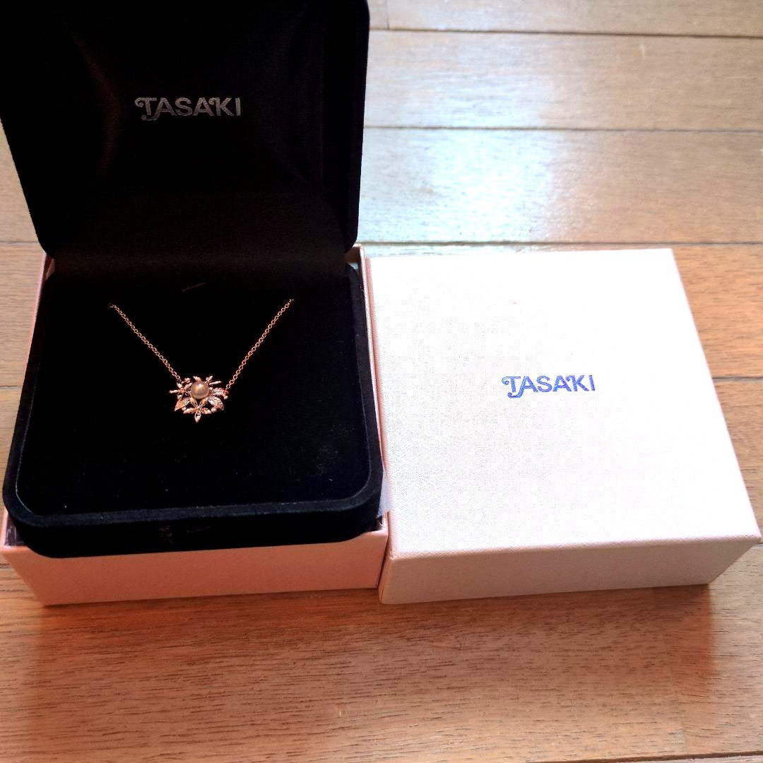 TASAKI flower-shaped pendant necklace displayed with original box on a white background