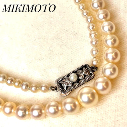 MIKIMOTO Graduation Necklace with cultured pearls and silver clasp on white background