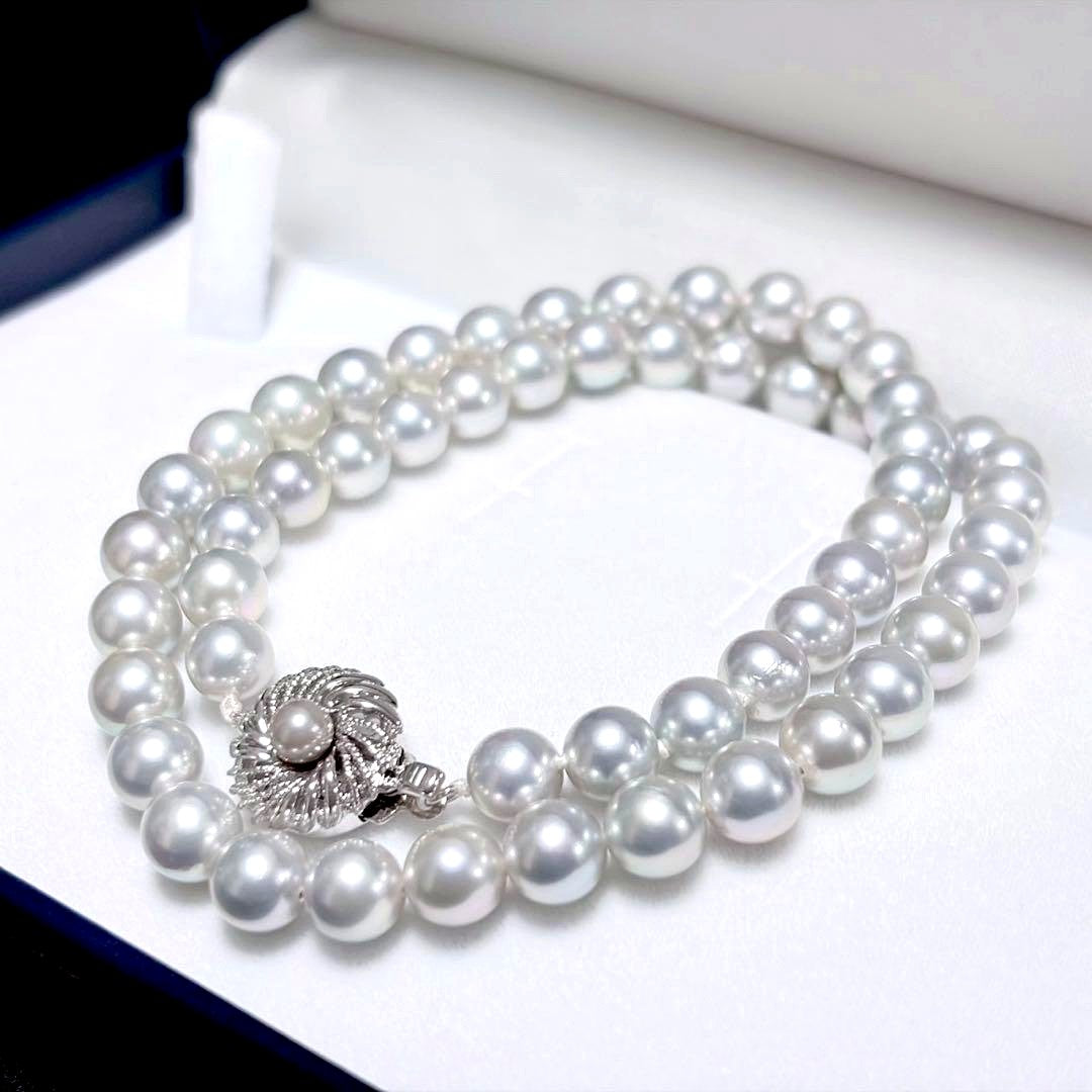 Akoya pearl necklace with 6.9-7.5mm light gray pearls and silver clasp on a white background