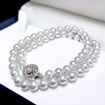Akoya pearl necklace with 6.9-7.5mm light gray pearls and silver clasp on a white background