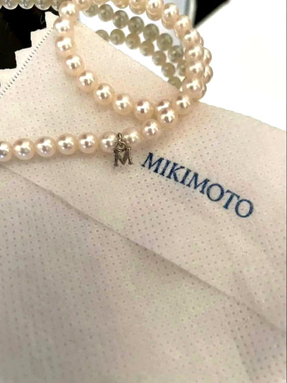 Mikimoto pearl necklace with silver M charm featuring 5 to 5.5 mm pearls and 43 cm silver clasp chain