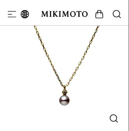 MIKIMOTO 18K gold necklace with pearl and diamond decorations displayed in a dedicated case