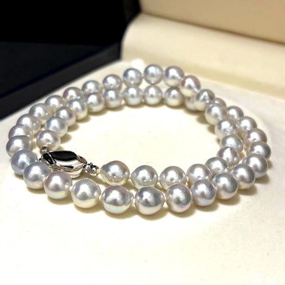 Akoya pearl necklace measuring 43.5 cm with round 8.0-8.5 mm white pearls on a white background