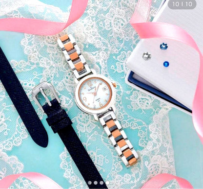 Casio solar-powered water-resistant watch with light blue dial and rose gold accents, including spare band