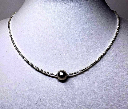 Akoya Keshi Necklace featuring small baroque pearls and a greenish pink Akoya pearl on a 42cm wire finish chain with metal clasp