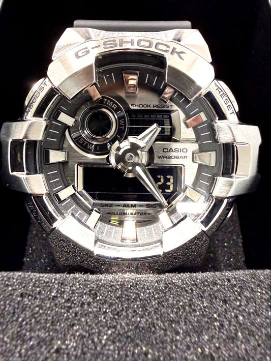 Casio G-Shock GM-700-1AJF Metal Covered Series watch with silver dial and resin band, shown with box and manual