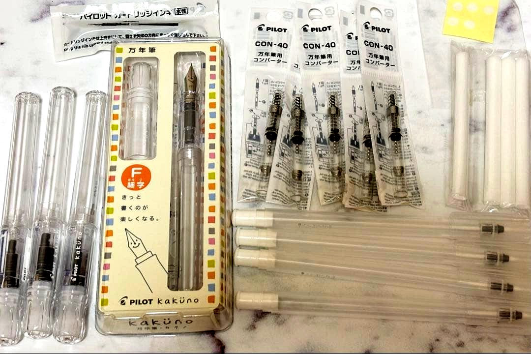 Set of 4 PILOT Kakuno fountain pens with fine nibs, 2 black ink cartridges, and 5 converters