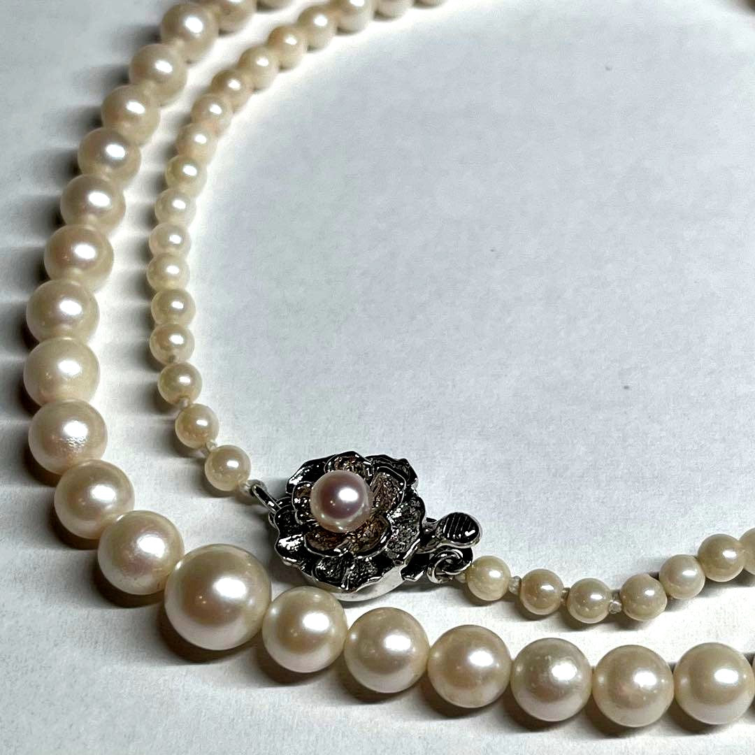 Aoya pearl necklace with cream baroque pearls and silver clasp on white background