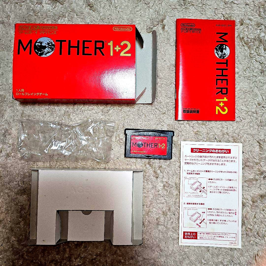 Nintendo GAMEBOY Advance handheld console with MOTHER1+2 game cartridge shown