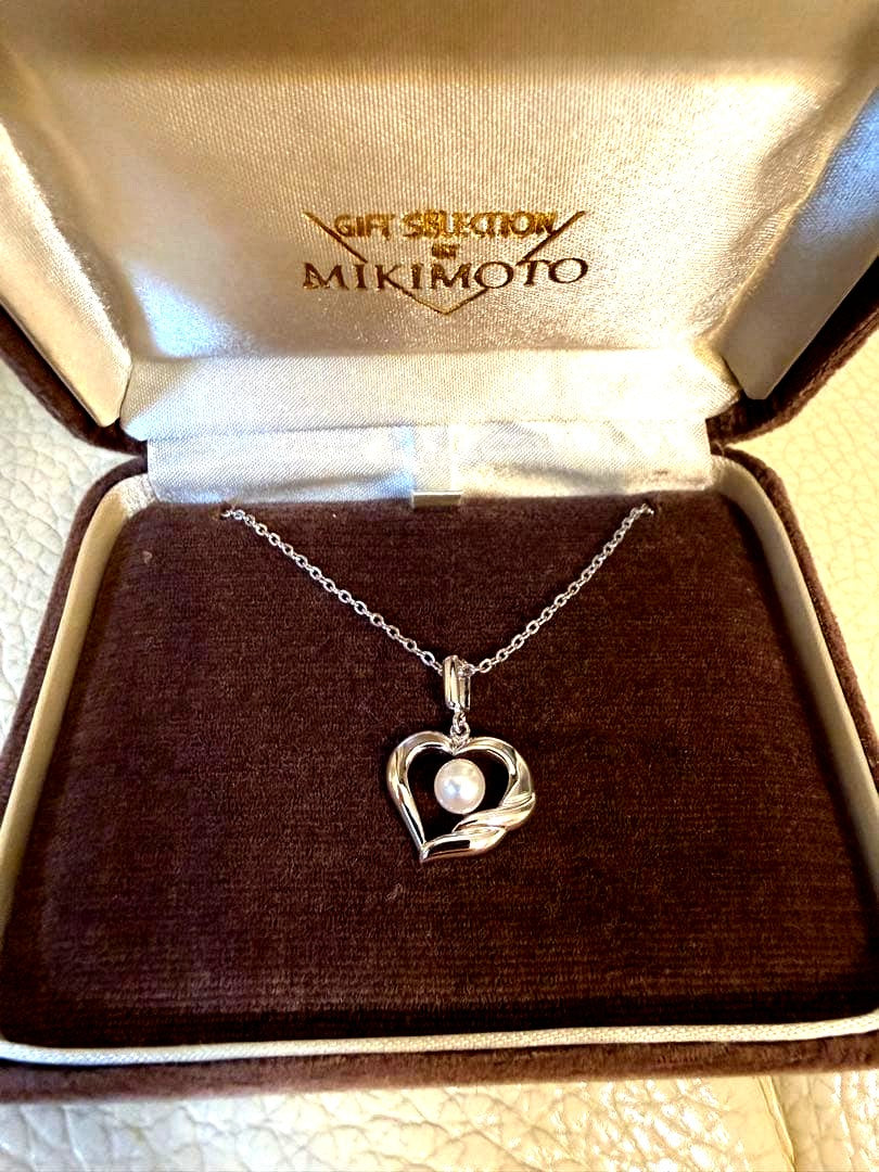 MIKIMOTO heart-shaped pearl necklace with silver pendant on white background