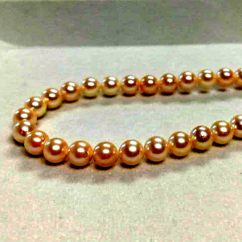 Law Akoya cultured pearl necklace with 6.5-7mm round white to cream pearls and silver clasp on a white background