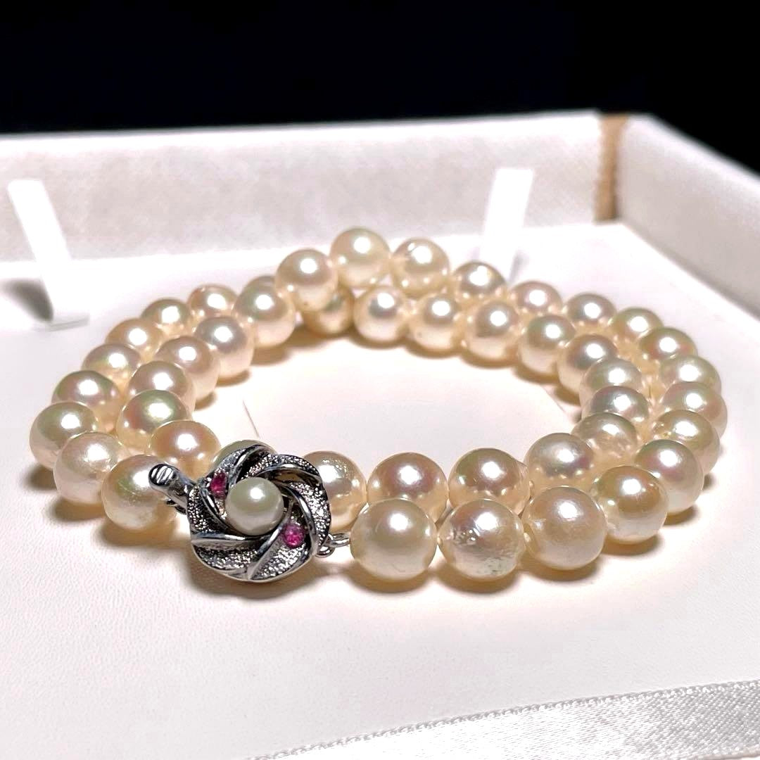 Oyster pearl necklace with round white pearls sized 8.3-8.8mm and ruby clasp with silver stamp