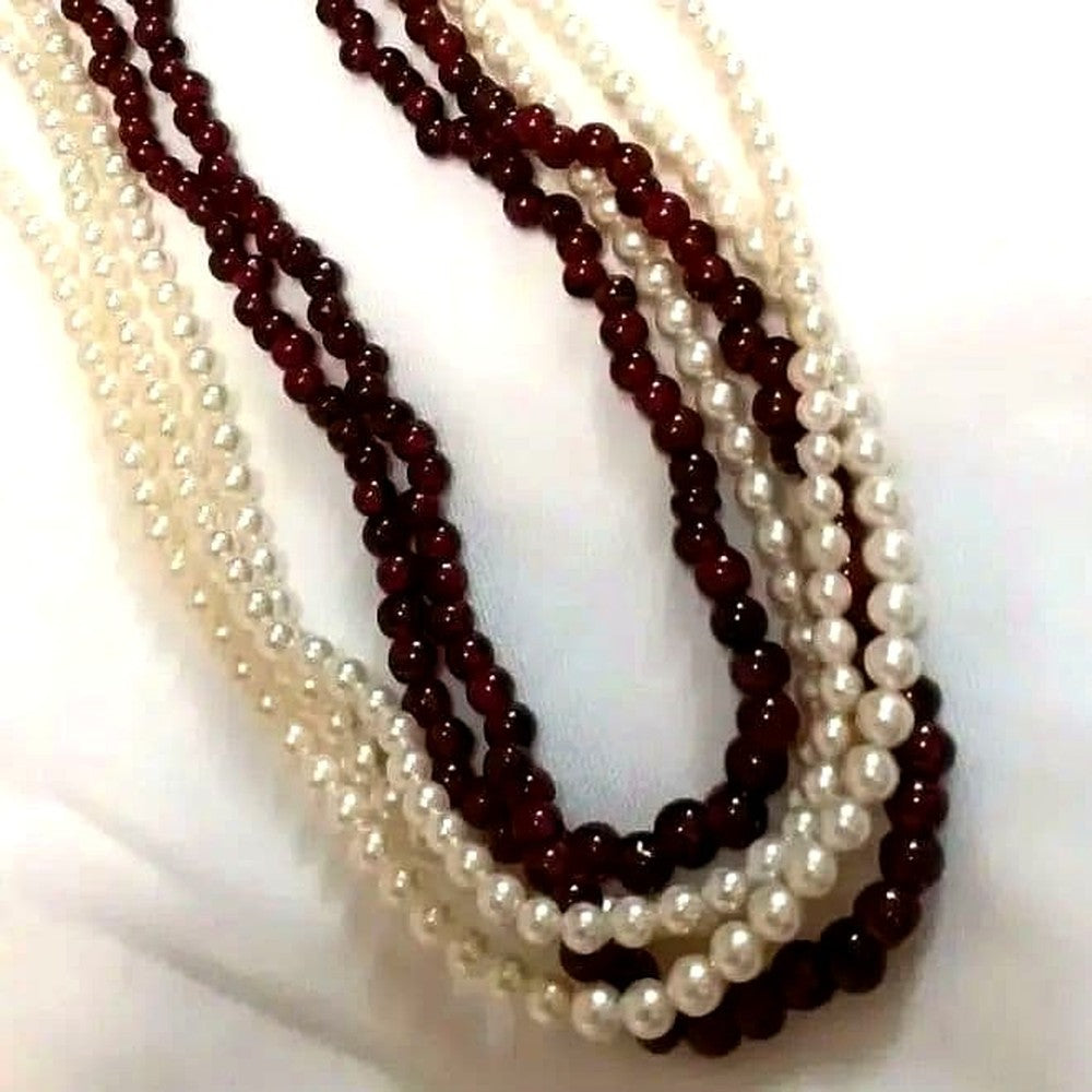 Five-row necklace with small round Akoya baby pearls and garnet stones showcasing high luster