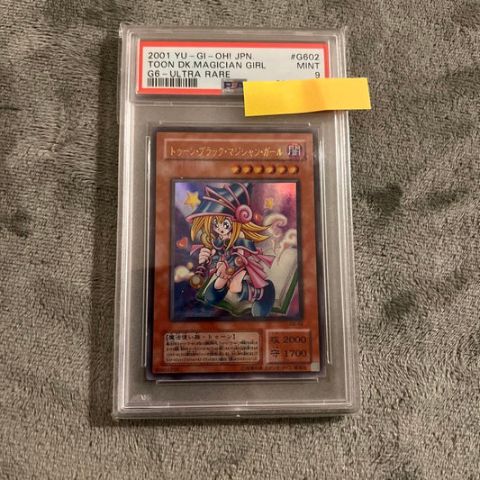 Ultra Rare Toon Dark Magician Girl Yu-Gi-Oh! trading card graded PSA 9 with Japanese text
