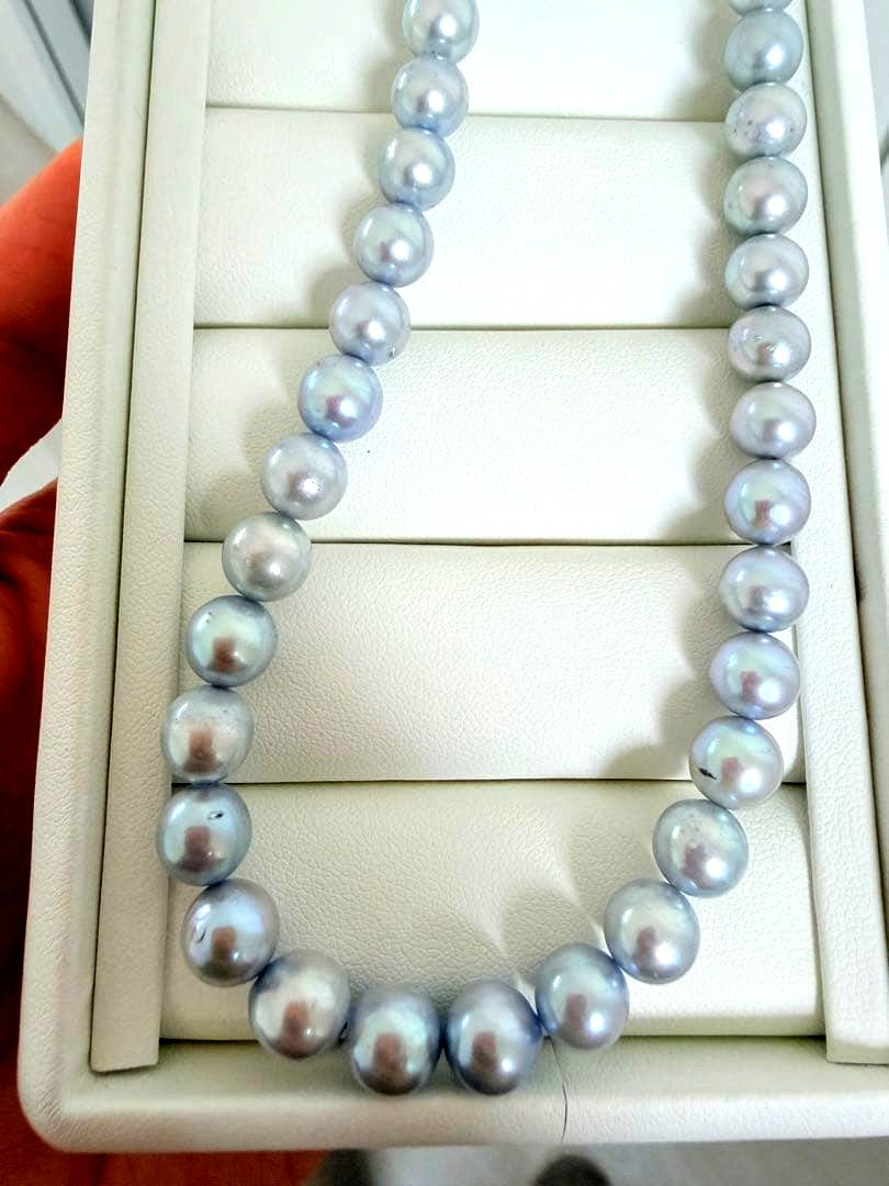 Akoya pearl necklace with 7-8mm ice blue gray semi-baroque pearls showing natural growth marks and gentle shine