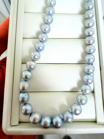 Akoya pearl necklace with 7-8mm ice blue gray semi-baroque pearls showing natural growth marks and gentle shine