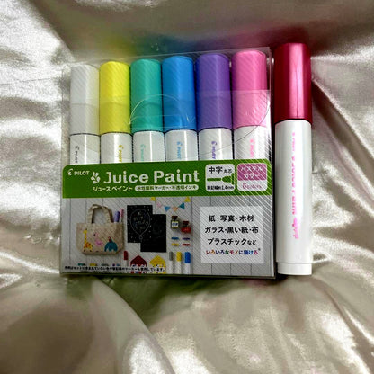 Juice Paint pastel color set with six water-based pigment ink pens and one red pen with medium round tip
