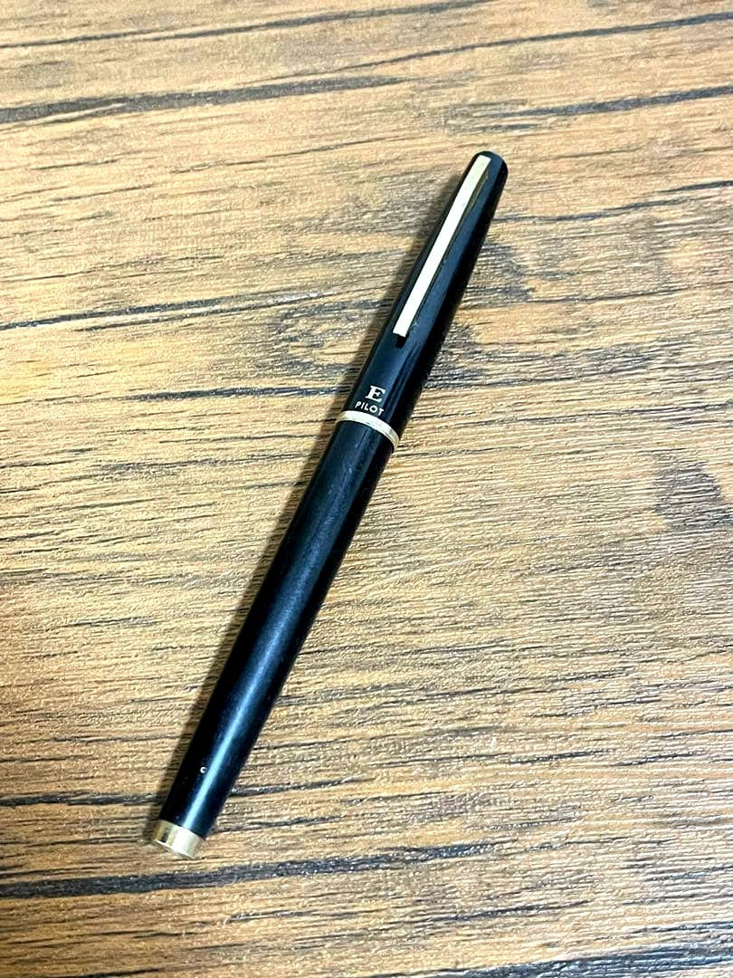 Pilot Fountain Pen E in black with gold trim featuring a soft inset nib