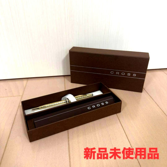 Gold CROSS ballpoint pen with diamond cut design displayed alongside original box