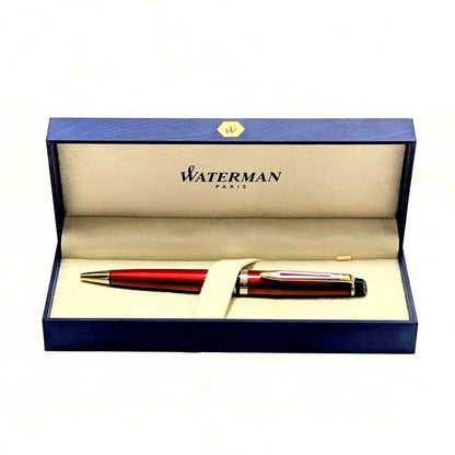 Waterman Expert dark red metal ballpoint pen with twist design alongside dedicated case