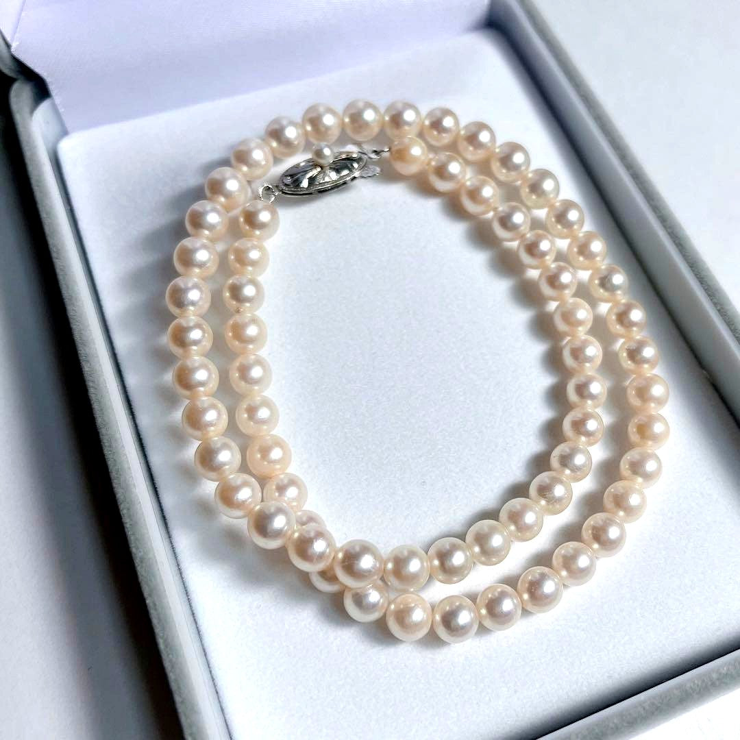 Close-up of 40cm Akoya pearl necklace with 6mm to 6.5mm pearls and silver engraved clasp on white background